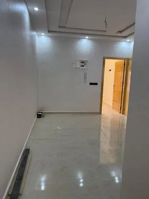 an empty room with a white wall and a hallway at Saidia in Oulad Akkou