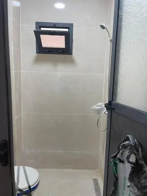 a bathroom with a toilet and a mirror on the wall at Saidia in Oulad Akkou