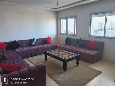 a living room with purple couches and a coffee table at pool view 105 meters in Oulad Akkou