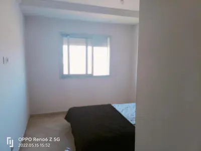a white room with a bed and a window at pool view 105 meters in Oulad Akkou