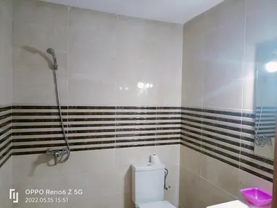a bathroom with a shower and a toilet in it at pool view 105 meters in Oulad Akkou