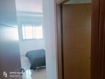 a bedroom with a bed and a door to a room at pool view 105 meters in Oulad Akkou