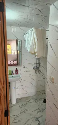 a bathroom with a sink and a mirror at CHALEt VILLA PISCINE PRIVÉE in Imouzzer Kandar