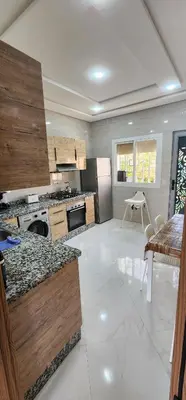 a large kitchen with a stove and a refrigerator at CHALEt VILLA PISCINE PRIVÉE in Imouzzer Kandar