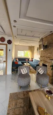 a living room with two chairs and a couch at CHALEt VILLA PISCINE PRIVÉE in Imouzzer Kandar