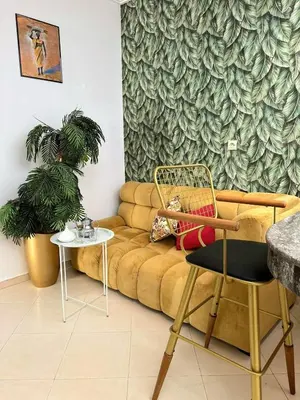 a living room with a couch and a table at Maison individuelle lazaret in Oulad Akkou
