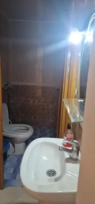 a bathroom with a white sink and a toilet at Maison individuelle lazaret in Oulad Akkou