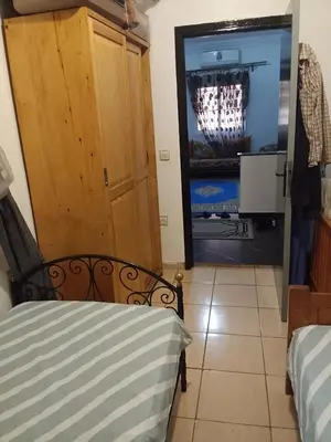 a bedroom with a bed and a tv in a room at Calme in Oulad Akkou