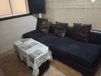 a blue couch with two pillows and a table at Calme in Oulad Akkou