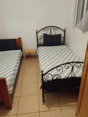 a bedroom with two twin beds in a room at Calme in Oulad Akkou