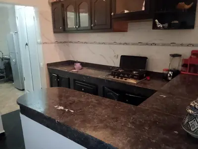 a kitchen with a stove and a counter top at Calme in Oulad Akkou