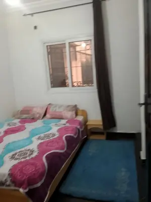 a bedroom with a bed and a window at Calme in Oulad Akkou