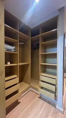 a closet with wooden shelves in a room at Comfortable and charming apartment in Oulad Akkou