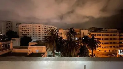 a view of a city with buildings and palm trees at Comfortable and charming apartment in Oulad Akkou