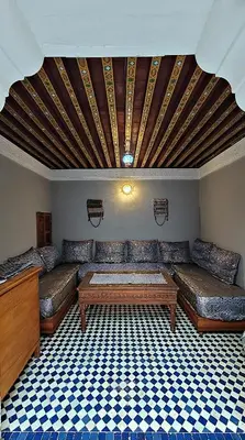 a living room with couches and a table at Riad Dar Bahija Fes in Fès