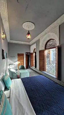 a large bedroom with a bed and a large window at Riad Dar Bahija Fes in Fès
