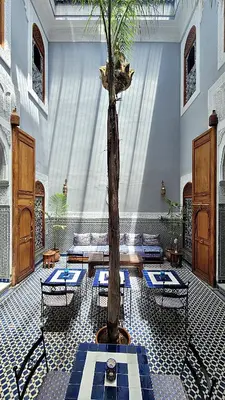 a room with a table and a tree in it at Riad Dar Bahija Fes in Fès