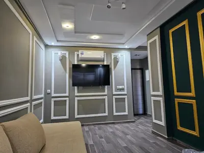 a living room with a tv and a couch at Cosy appartement in Oulad Akkou