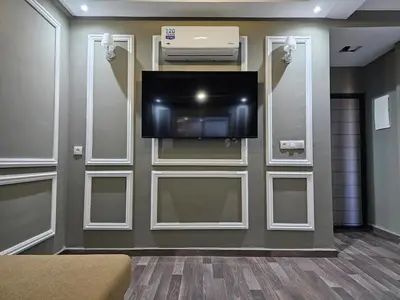 a room with a flat screen tv on a wall at Cosy appartement in Oulad Akkou