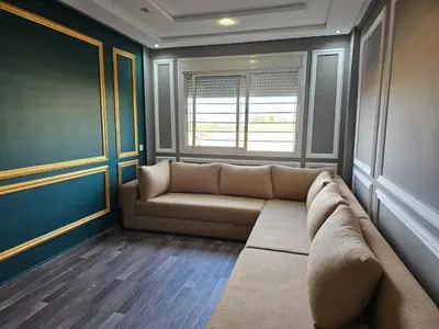 a living room with a couch and a window at Cosy appartement in Oulad Akkou