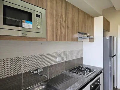 a kitchen with a sink and a microwave at Cosy appartement in Oulad Akkou