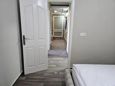 a hallway with a white door leading to a bedroom at Cosy appartement in Oulad Akkou