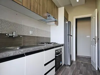 a kitchen with a sink and a counter top at Cosy appartement in Oulad Akkou