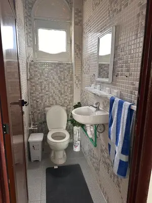 a small bathroom with a toilet and a sink at Dar Kenza in Fès