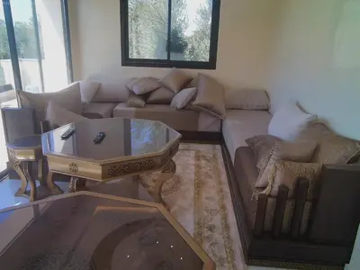 a living room with a couch and a coffee table at Villa Ghmat in Aït Ali Ou Allah