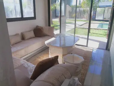 a living room with a couch and a table at Villa Ghmat in Aït Ali Ou Allah
