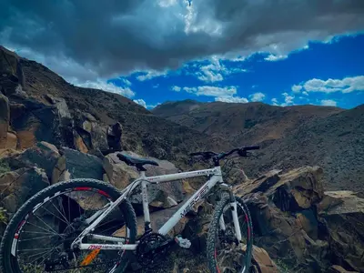 a bike parked on top of a rocky mountain at imintanoute abderrahim in Oulad Akkou