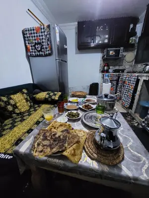 a table with food on it in a kitchen at imintanoute abderrahim in Oulad Akkou