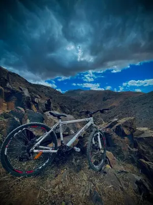a bike sitting on top of a rocky mountain at imintanoute abderrahim in Oulad Akkou