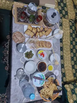 a table with many different types of food on it at imintanoute abderrahim in Oulad Akkou