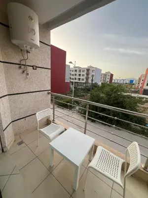 a white table and chairs on a balcony with a view at Maison in Oulad Akkou