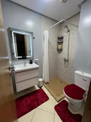a bathroom with a sink and a toilet and a mirror at Maison in Oulad Akkou