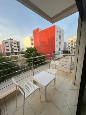 a balcony with a table and chairs and a view at Maison in Oulad Akkou