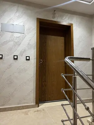 a wooden door in a wall with a staircase at Maison in Oulad Akkou