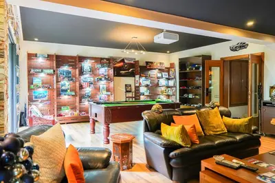 a living room with a couch and a pool table at The Classic Affair For Car Lovers in Oulad Akkou