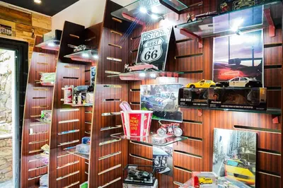 a room with wooden walls and shelves with toy cars at The Classic Affair For Car Lovers in Oulad Akkou