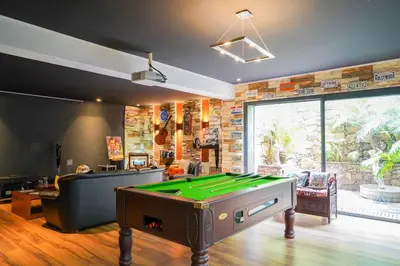 a living room with a pool table in it at The Classic Affair For Car Lovers in Oulad Akkou