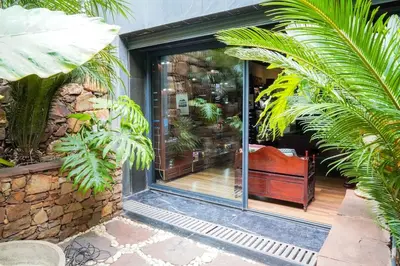 a room with a window with a chair and plants at The Classic Affair For Car Lovers in Oulad Akkou