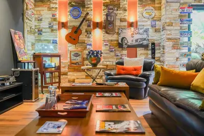 a living room with couches and a stone wall at The Classic Affair For Car Lovers in Oulad Akkou