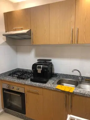 a kitchen with a stove and a sink at Appartement Nour sakane targa kech in Oulad Akkou