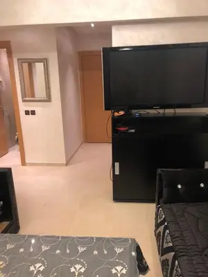 a living room with a large flat screen tv at Appartement Nour sakane targa kech in Oulad Akkou