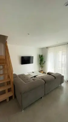 a living room with a couch and a flat screen tv at Duplex confortable in Oulad Akkou