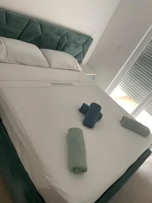 a large white bed with two pillows on it at Duplex confortable in Oulad Akkou