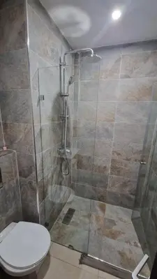 a bathroom with a shower with a toilet in it at Duplex confortable in Oulad Akkou