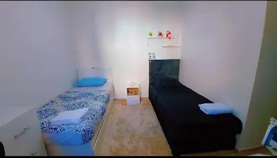 a small room with two beds in it at شقةبالقرب من مطار مراكش المنارة الدولي in Oulad Akkou