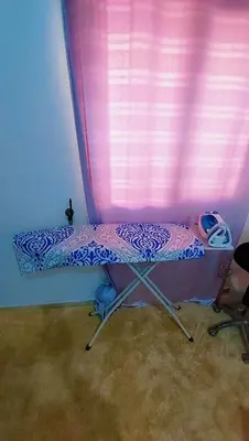 a small bed in a room with a pink curtain at شقةبالقرب من مطار مراكش المنارة الدولي in Oulad Akkou